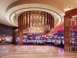 Live casino dealer at roulette table with multi-camera setup